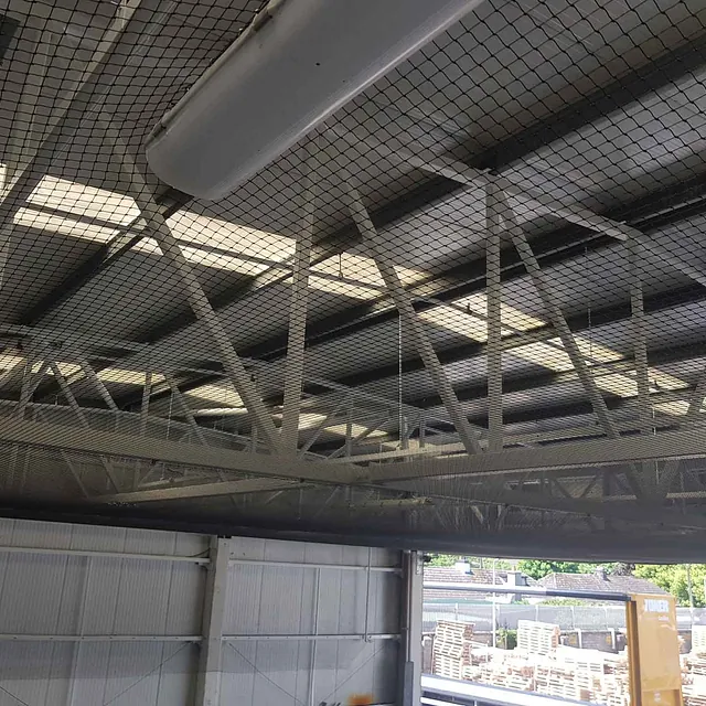 Close up of bird netting installed in a warehouse